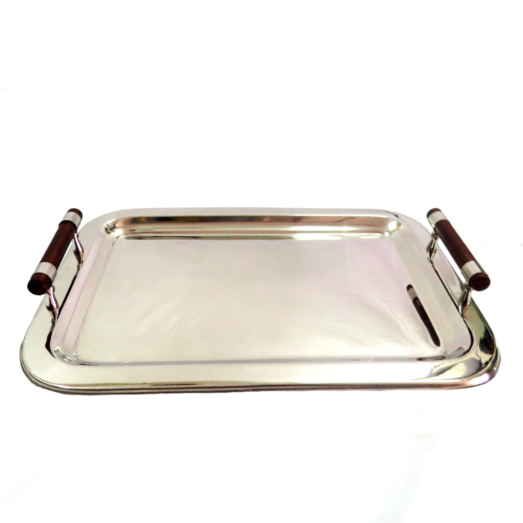 Expertly crafted with mirror polished, stainless steel, the Trade Off Tray measures 56cm in length and 40cm in width. Its wooden handles exude elegance and functionality, making it the perfect tray for any occasion. Elevate your serving game with this sleek and stylish Trade Off Tray-unique interiors