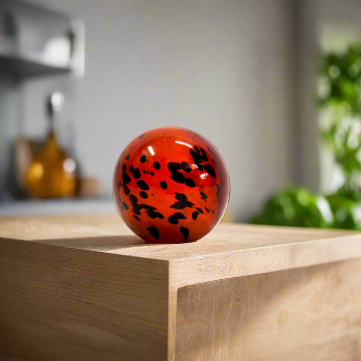 Introducing the Exquisite Ingwe Glass Ball
Elevate your home decor with the stunning Ingwe Glass Ball, expertly handcrafted to showcase rich amber tones and unique dark markings. This solid glass ball is a masterpiece of natural beauty, evoking a sense of wonder and awe