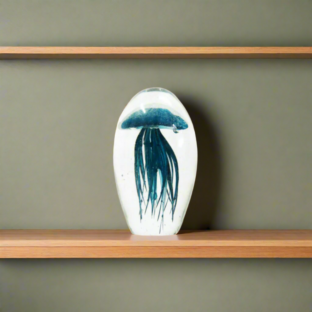 Palau 12cm
Elevate your space with the breathtaking Palau 12cm!
Key Features:
Expert Craftsmanship: Handmade with heavy and clear glass
Unique Design: Captivating peacock blue jellyfish shape with intricate tentacles
Compact Size: Stands at 12.5cm in height, 8cm in diameter, and 23cm in circumference