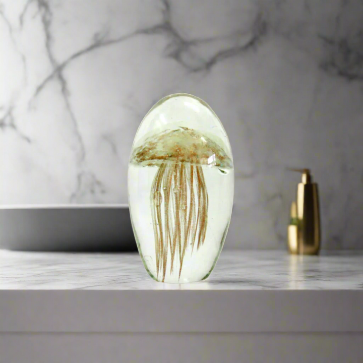 Octo Decorative Piece
Add a Touch of Underwater Magic to Your Space!
The Octo 12cm is a breathtakingly beautiful, handmade clear glass decorative piece that stands at 12cm. Adorned with a stunning jellyfish shape in frosted gold and spun copper tentacles, this piece is truly a sight to behold.