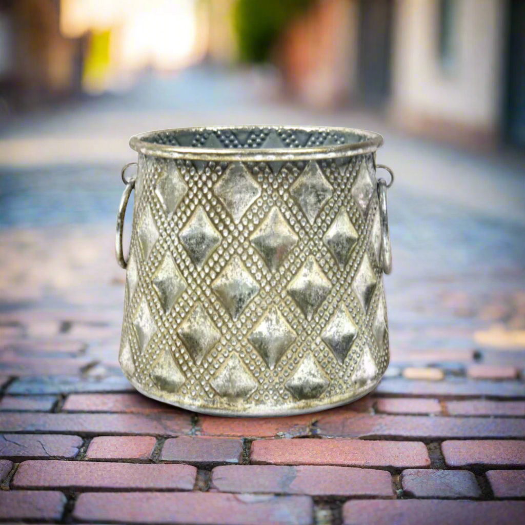 Manalini Vase
Product Description
Elevate your space with the elegant Manalini Vase. This versatile, metal container boasts an attractive surface pattern and antique silver finish. Use it as a candle lantern, vase, or planter for a touch of sophistication.