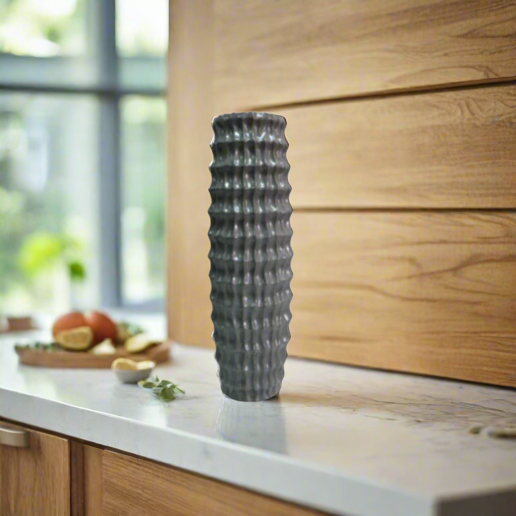 Kith Vase - Modern Ceramic Statement Piece
Make a statement in your decor with the striking and modern Kith vase. This stunning ceramic grey vase boasts a sleek design, perfect for showcasing longer stemmed blooms and greenery. With its impressive 16cm diameter x 50.5cm height, the Kith vase is sure to elevate your space.