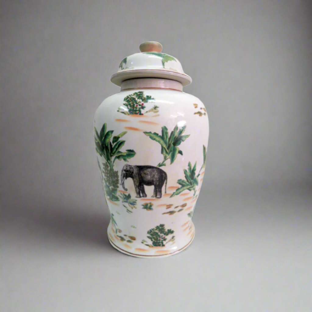 Bring Exotic Elegance to Your Space with the Palm Elephant Ginger Jar
Add a touch of the exotic East to your home or office with the stunning Palm Elephant Ginger Jar. This beautiful ceramic jar features vivid, hand-painted images of an elephant and palm leaves, evoking a sense of tropical elegance.
Hand-Painted Masterpiece
Crafted from fine ceramic, this jar is a true masterpiece of craftsmanship. The intricate, hand-painted design adds a touch of uniqueness and sophistication to any room.