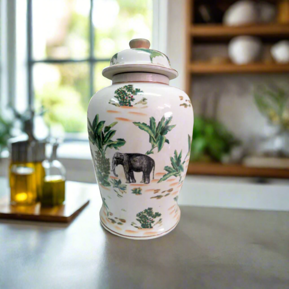 Bring Exotic Elegance to Your Space with the Palm Elephant Ginger Jar
Add a touch of the exotic East to your home or office with the stunning Palm Elephant Ginger Jar. This beautiful ceramic jar features vivid, hand-painted images of an elephant and palm leaves, evoking a sense of tropical elegance.
Hand-Painted Masterpiece
Crafted from fine ceramic, this jar is a true masterpiece of craftsmanship. The intricate, hand-painted design adds a touch of uniqueness and sophistication to any room