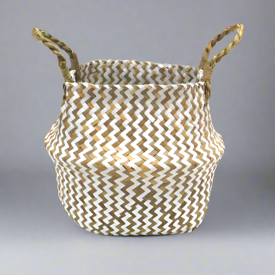 Product Details: Persell Basket
Description: A unique and beautifully finished basket featuring chevron weaving in white and natural colors.
Material: Natural fibers with twisted handles
Size: 22cm x 28cm x 24cm
Features:
Chevron weaving pattern
Natural twisted handles for a secure grip
Uses:
Outdoor decor: Add a touch of natural elegance to your patio, garden, or pool area.
Storage: Perfect for storing books, magazines, or other small items.
Store: Unique Boys, offering trendy decor that stays forever in s