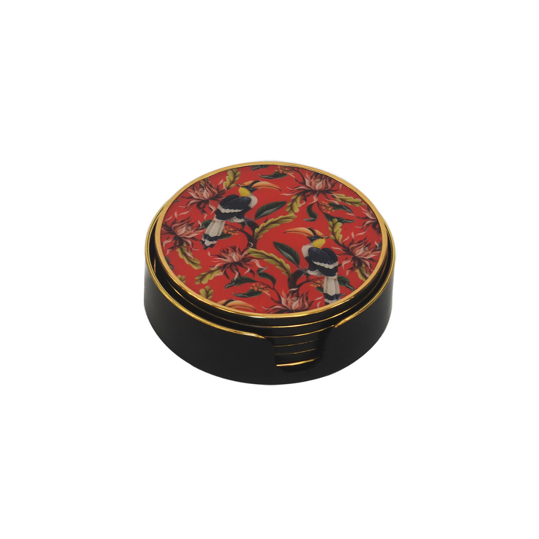 Enhance your home decor with this set of six sophisticated coasters. Constructed with premium, long-lasting material, these coasters offer exceptional protection and longevity. The eye-catching red toucan design brings a distinct flair to any dining table.  Unique Interiors.