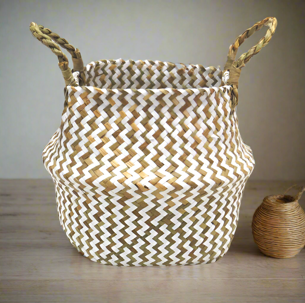 Product Details: Persell Basket
Description: A unique and beautifully finished basket featuring chevron weaving in white and natural colors.
Material: Natural fibers with twisted handles
Size: 22cm x 28cm x 24cm
Features:
Chevron weaving pattern
Natural twisted handles for a secure grip
Uses:
Outdoor decor: Add a touch of natural elegance to your patio, garden, or pool area.
Storage: Perfect for storing books, magazines, or other small items.
Store: Unique Boys, offering trendy decor that stays forever in s