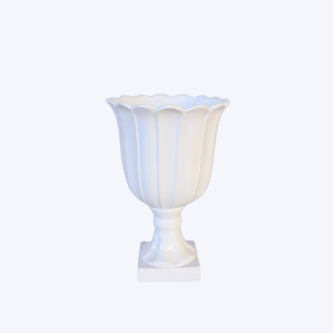 This medium-sized white vase or urn, measuring at 35X24CM, is versatile and elegant. Perfect for displaying flowers or as a stand-alone piece, it adds a touch of sophistication to any room. Crafted with high-quality materials, it is durable and timeless. <span style="font-size: 0.875rem;">Display your favorite flowers or use it as a standalone statement piece. The possibilities are endless. Unique Interiors