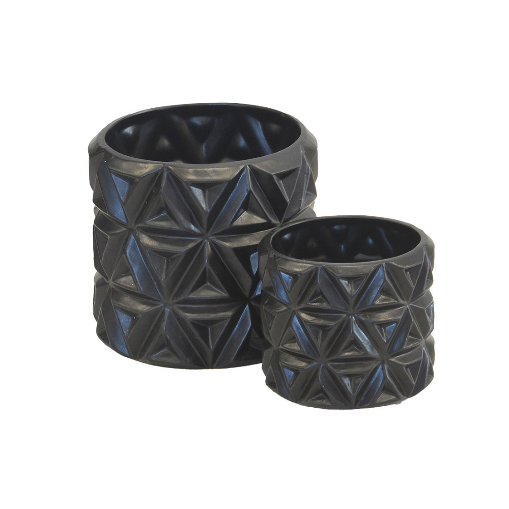 This set of two ceramic planters features a carved flower design with a matte black finish. The larger one measures 16cm in height and 16cm in diameter, while the smaller one is 12cm in height and 12cm in diameter. Both are crafted of ceramic porcelain for long-lasting use and are sure to add a unique decorative touch to any interior.  Ceramic carved flower matt black s/2  Size  16CM (H) X 16CM (D)  12CM (H) X 12CM (D)  Ceramic porcelain decor planter pot.  Unique Interiors