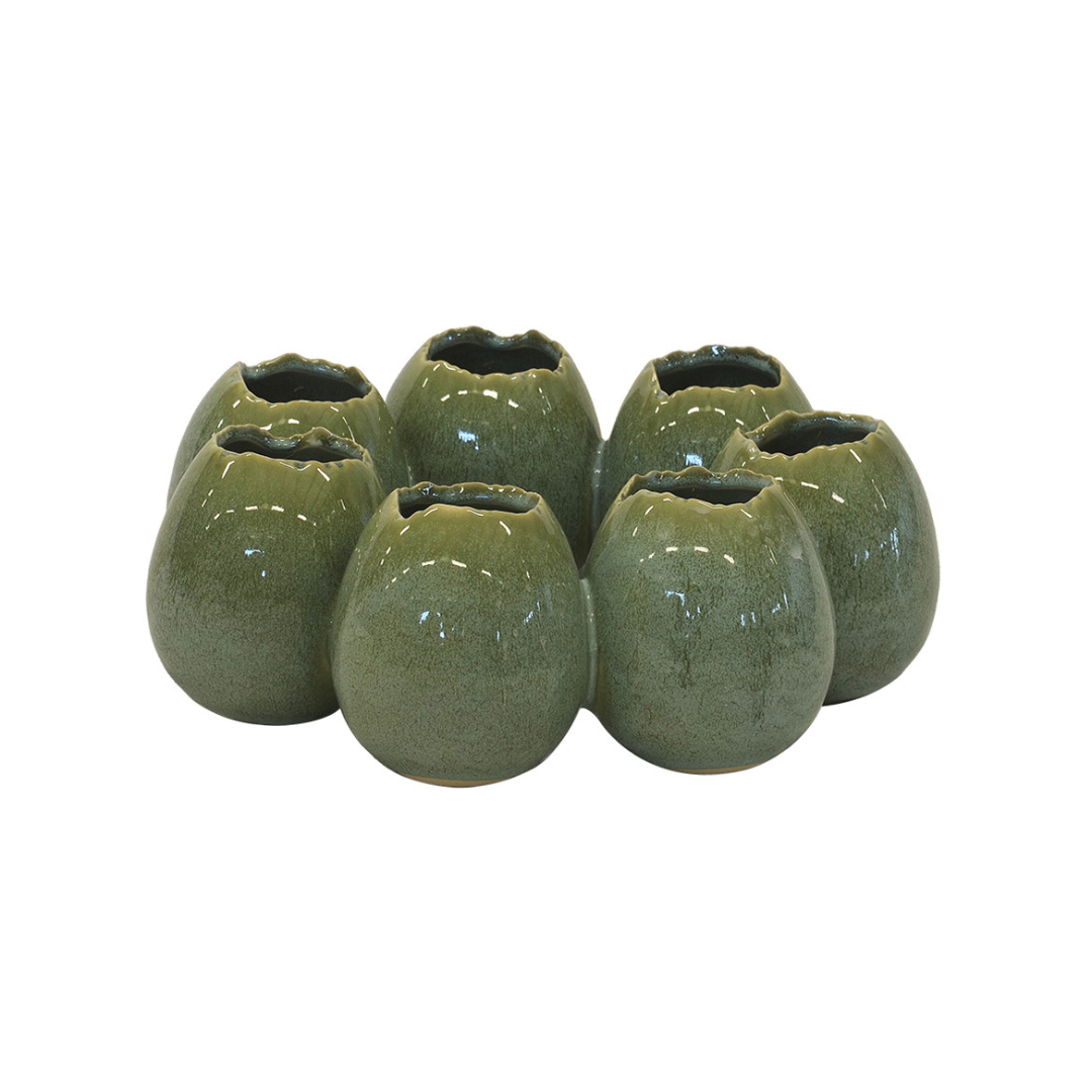 Crafted from high-quality ceramic, this Ostrich Egg Ring Vase in green is a stunning addition to any home decor. Measuring 25CM in diameter and 10CM in height, it is perfect for displaying your favorite flowers or as a standalone piece. Elevate your interior design with this unique and elegant vase-UNIQUE INTERIORS