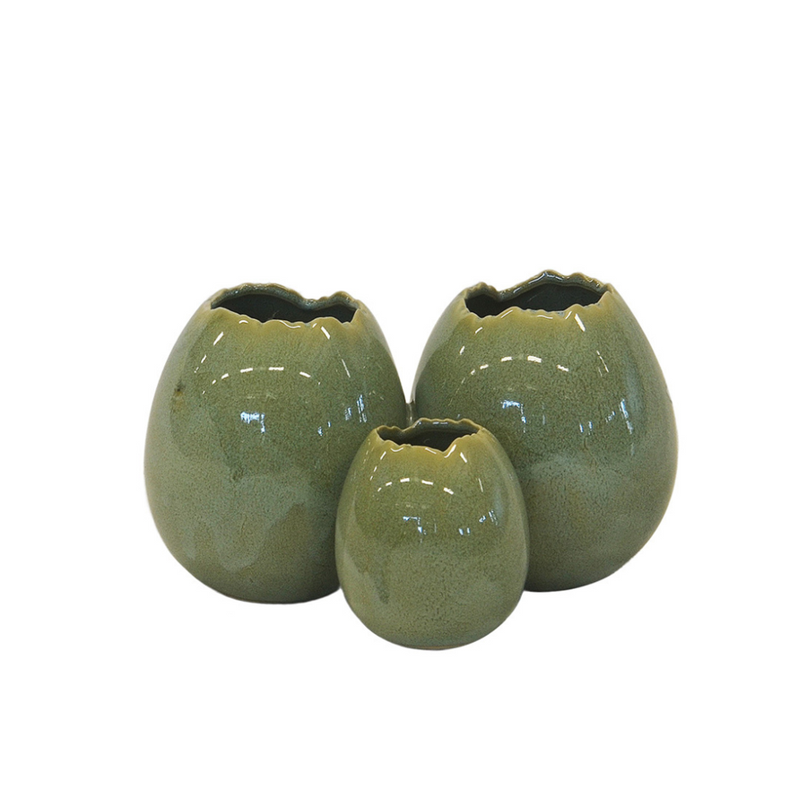 Introduce your space to a touch of exotic luxury with our Ceramic Ostrich Egg Ring Vase in Green. This small-sized vase boasts dimensions of 16CM x 10CM x 10CM (H), making it the perfect accent piece for any tabletop or shelf. Its unique design adds a sophisticated touch to any room, creating a statement piece that is both functional and stylish. Elevate your home decor with this eye-catching vase today-UNIQUE INTERIORS