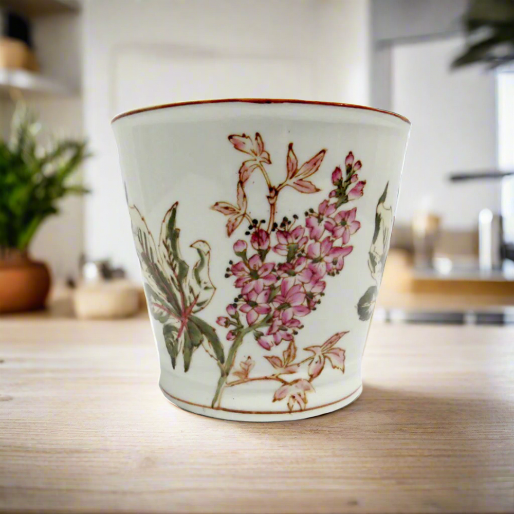 Wildflower Planter
Add a touch of whimsy and elegance to your garden or interior space with our exquisite Wildflower Planter. This charming planter features a beautiful, hand-painted design in soft pinks and greens on a stunning porcelain pot.