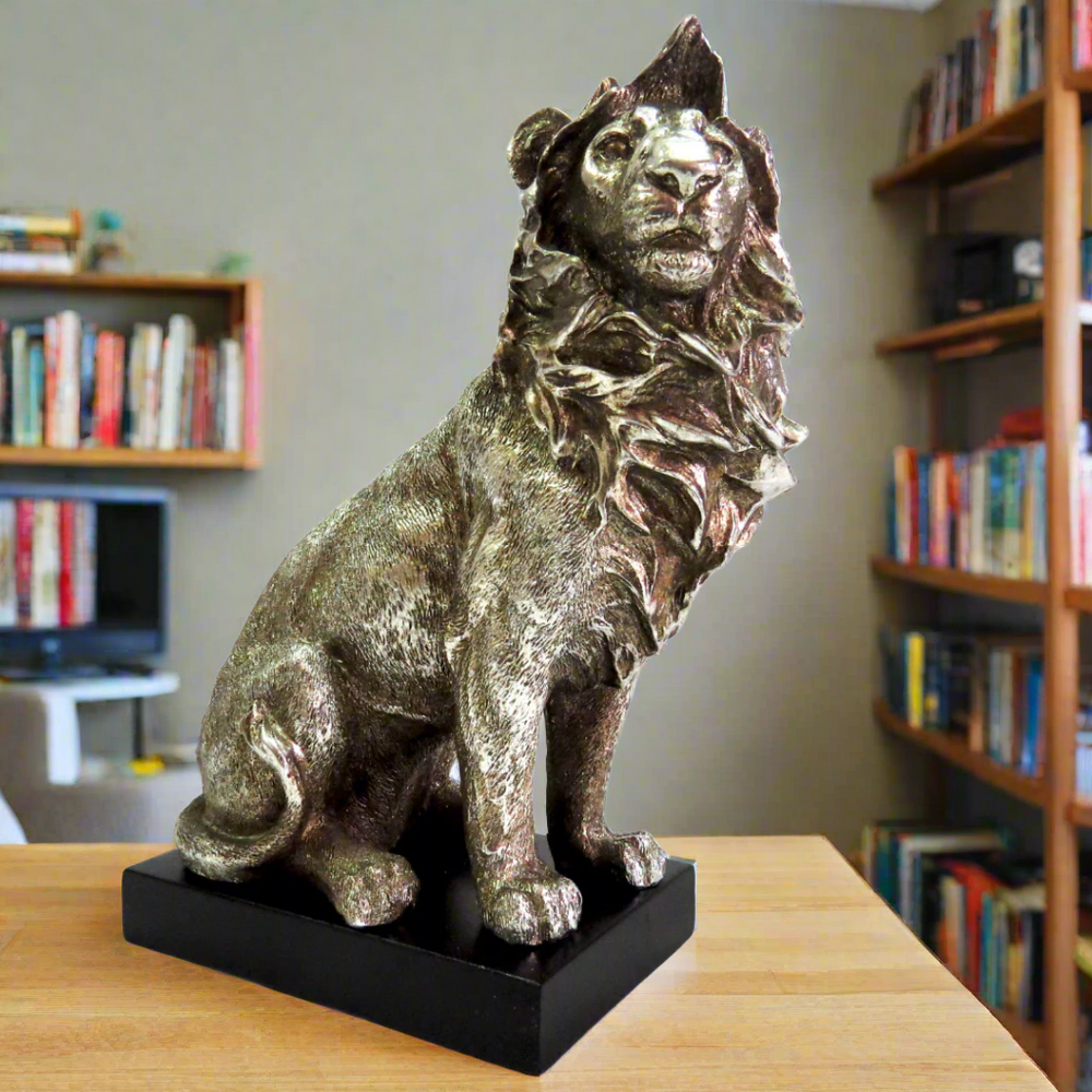 Product Description: Zimbo Lion
Introducing the majestic Zimbo Lion, a stunning antique silver collectible that's sure to impress. This beautifully crafted lion stands proudly on a black plinth, showcasing its impressive size and intricate details.