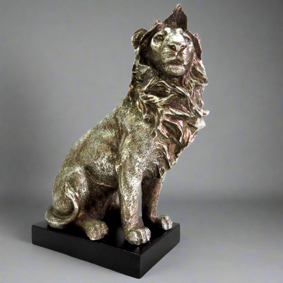 Product Description: Zimbo Lion

Introducing the majestic Zimbo Lion, a stunning antique silver collectible that's sure to impress. This beautifully crafted lion stands proudly on a black plinth, showcasing its impressive size and intricate details.