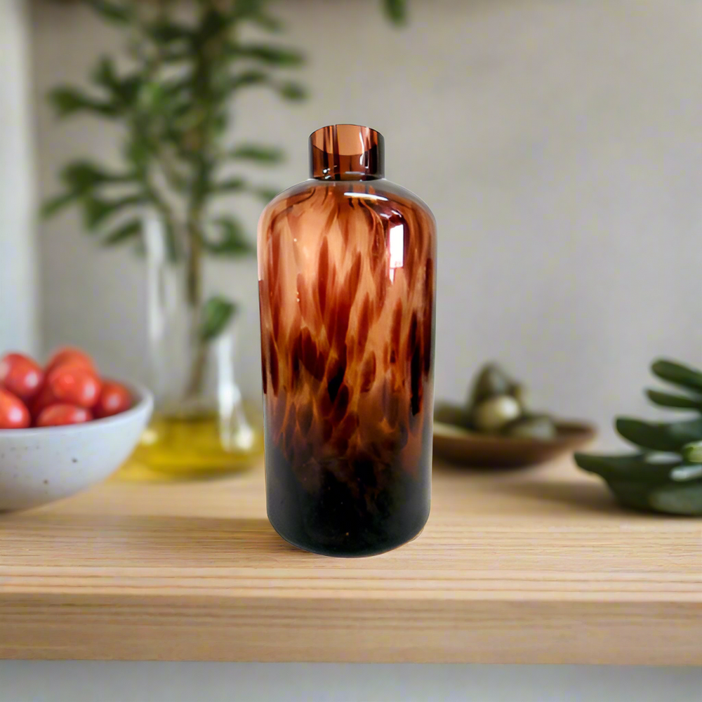 Elevate Your Space with the Exquisite Nuru Vase
Add a touch of sophistication and elegance to your home with the stunning Nuru Vase. This unique, jar-shaped glass container boasts a beautiful tortoise shell design that's sure to impress.